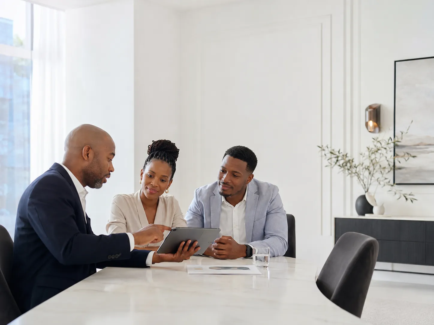 South African financial adviser discussing investment and retirement goals with clients